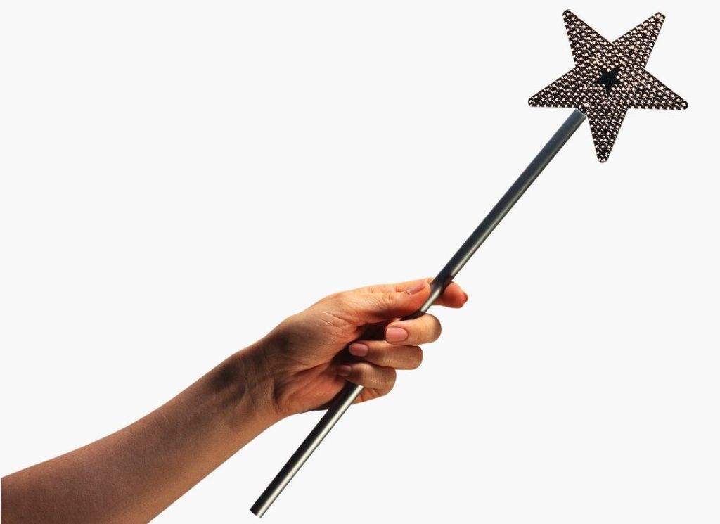 Mano sosteniendo una varita magica con una punta de estrella